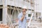 Hispanic Latin foreman engineer builder enjoy working radio command in home construction site happy smile