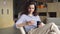 Hispanic latin young girl student holding smartphone and coffee in modern space.