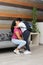 Hispanic Latino mom and son prepare for back to school in uniform and backpack say goodbye in the morning