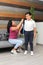 Hispanic Latino mom and son prepare for back to school in uniform and backpack say goodbye in the morning