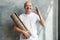 Hispanic male pensioner looking at camera while holding yoga mat in hands