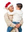 Hispanic Male Soldier Wearing Santa Cap Holding Mixed Race Son Isolated on a White Background