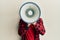 Hispanic man with beard screaming with megaphone