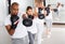 Hispanic man in boxing gloves during group self-defense workout