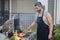 Hispanic man cooking on barbecue in the backyard. Chef preparing barbecue. Barbecue chef master. Handsome man preparing
