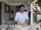 Hispanic man cutting star fruit with knife