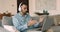 Hispanic man in headphones using laptop and videoconference application