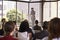 Hispanic man presenting business seminar leaning on lectern