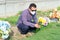 Hispanic Man with protective mask placing flowers on a grave. Coronavirus epidemic
