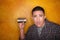 Hispanic man with tin can telephone