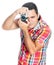 Hispanic man using a vintage looking compact camera