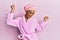 Hispanic man wearing make up wearing shower towel cap and bathrobe dancing happy and cheerful, smiling moving casual and confident