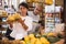 Hispanic married couple choosing bananas in grocery store