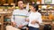 Hispanic married couple visiting grocery store for shopping