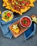 Hispanic mexican food, nachos with meat, corn and halapenjo on dark background