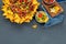 Hispanic mexican food, nachos with meat, corn and halapenjo on dark background