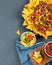 Hispanic mexican food, nachos with meat, corn and halapenjo on dark background