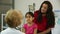 Hispanic mom listens intently to what doctor says about sick child