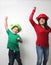 Hispanic mom and son play, jump and have fun together with funny hats spend quality family time very happy