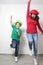 Hispanic mom and son play, jump and have fun together with funny hats spend quality family time very happy