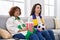 Hispanic mother and daughter watching football supporting team thinking attitude and sober expression looking self confident