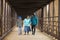 Hispanic Mother Walks With Sons On A Bridge