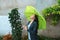 A Hispanic pretty, cheerful girl holding an umbrella as she walks outside in the rain