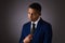 Hispanic Teenager Boy Well Dressed on Gray Background Looking Away from Camera and Deeply Pondering