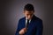 Hispanic Teenager Boy Well Dressed on Gray Background Looking Away from Camera and Deeply Pondering