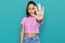 Hispanic teenager girl with dental braces wearing casual clothes doing stop sing with palm of the hand