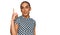 Hispanic transgender man wearing make up and long hair wearing modern clothes showing and pointing up with finger number one while