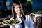 Hispanic waitress in restaurant serving salads