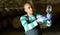 Hispanic winemaker checking quality of wine in winery vault