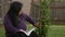 Hispanic Woman Admires Tree While Holding Bible