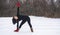 Hispanic woman doing yoga positions outside in winter