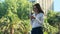 Hispanic woman with glasses typing message in social media on the street