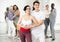 Hispanic woman and guy learning pair dances in choreography class