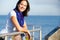 Hispanic Woman Looking Over Railing At Sea