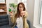 Hispanic woman playing colorful puzzle cube intelligence game pointing with finger to the camera and to you, confident gesture