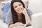 Hispanic Woman Reading Paperback Book at Home