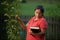 Hispanic Woman Touching Pear Tree and Contemplating her Bible