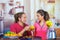 Hispanic young healthy couple enjoying breakfast together, sharing fruits, drinking orange juice and smiling, home