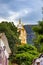 Historic 18th century church tower seen through trees and houses