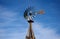 Historic Aermotor Windmill water pump at Rika`s Landing Roadhouse, against a blue, almost cloudless sky