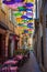 Historic alley and restaurant in BÃ©ziers in France in the shade of umbrellas