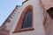 Historic antique large church window, ornate window glass and old masonry, daytime, without people