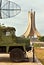 Historic army vehicle with antenna and in the background of the Martyrs Memorial, Maqam Echahid, Algiers, Algeria