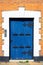 Historic blue wooden front door with six letterboxes