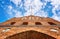 Historic brick city gate under a blue sky with clouds in the Hanseatic city of Wismar on the Baltic Sea