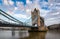 Historic Bridge over River Thames and Cityscape Skyline during dramatic sunrise.